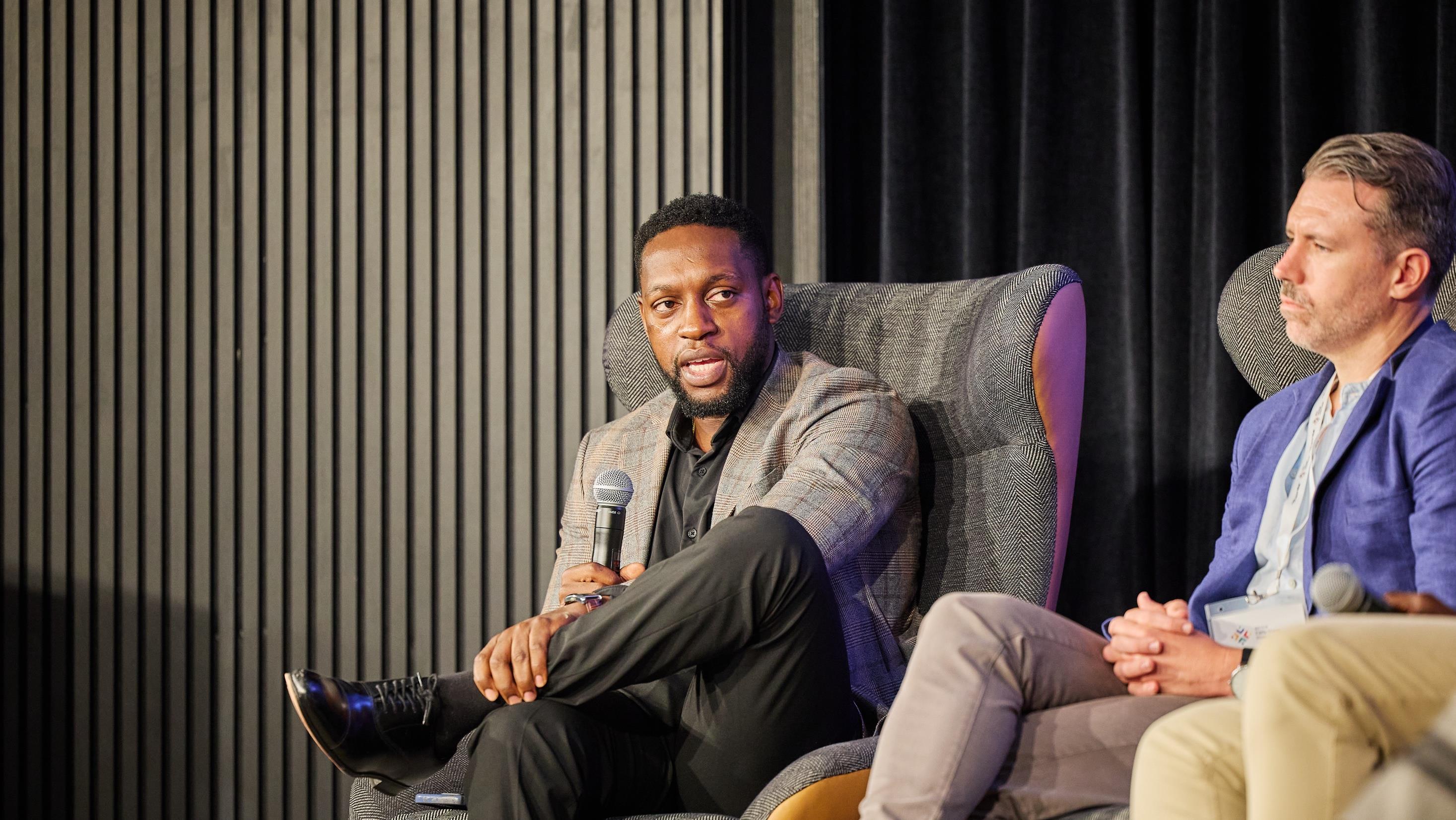 Local investors in conversation on stage at an investor gathering