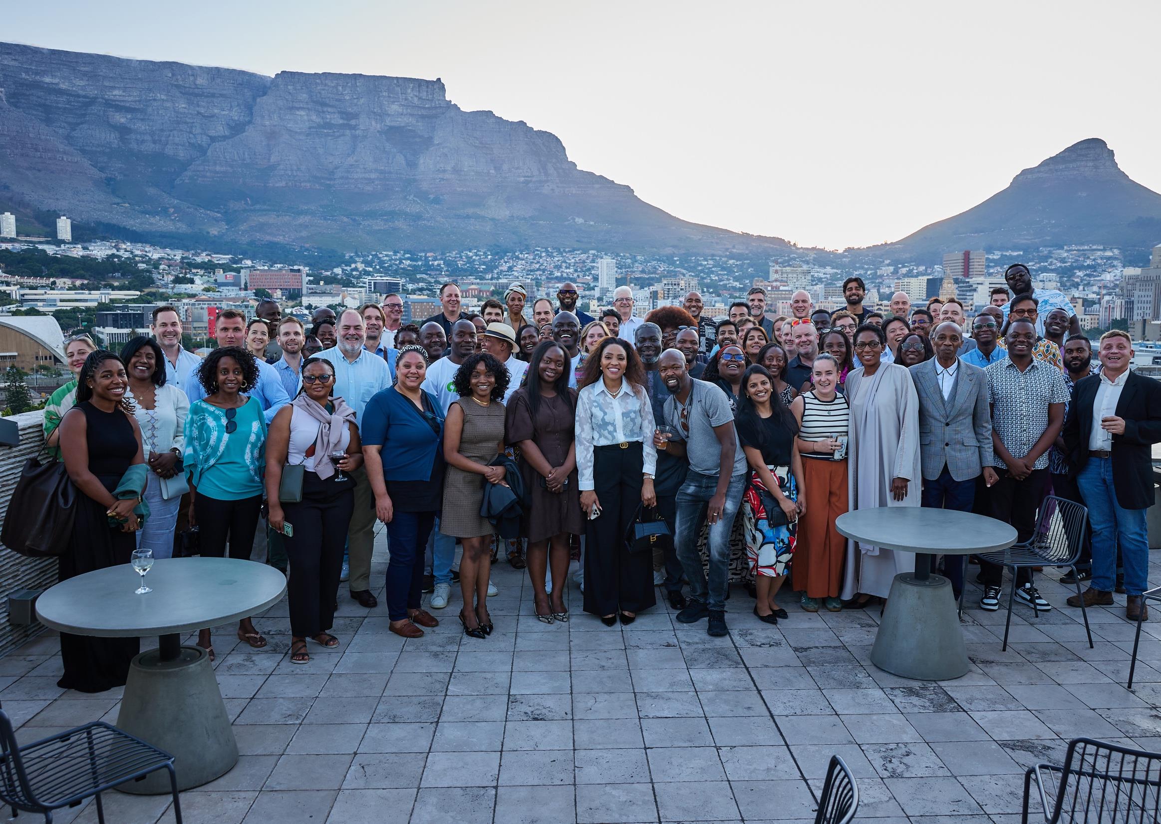 Investors, founders and business leaders gathered at a Cape Town rooftop reception with Table Mountain behind them